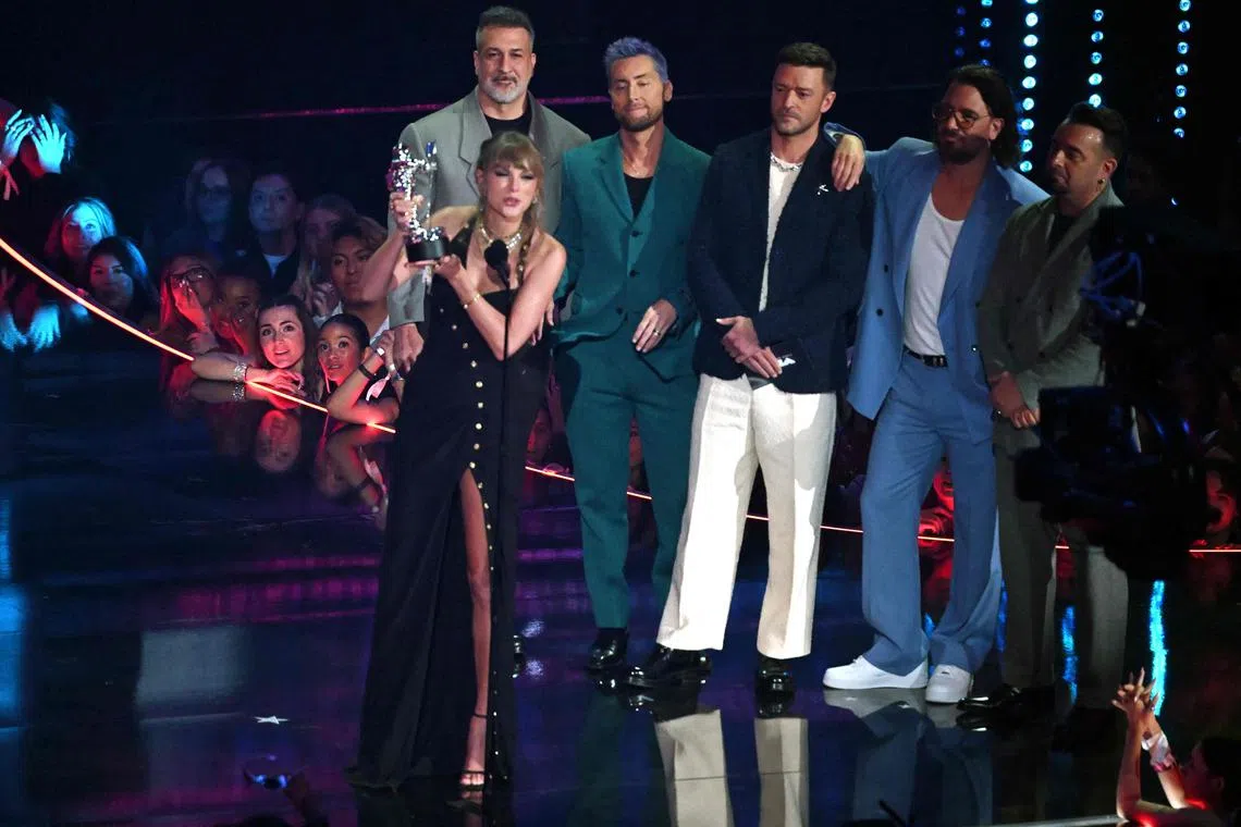 US singer-songwriter Taylor Swift accepts the award for Best Pop Video, presented by NSync members (from left) Joey Fatone, Lance Bass, Justin Timberlake, JC Chasez and Chris Kirkpatrick, onstage during the MTV Video Music Awards at the Prudential Center in Newark, New Jersey, on Sept 12, 2023.