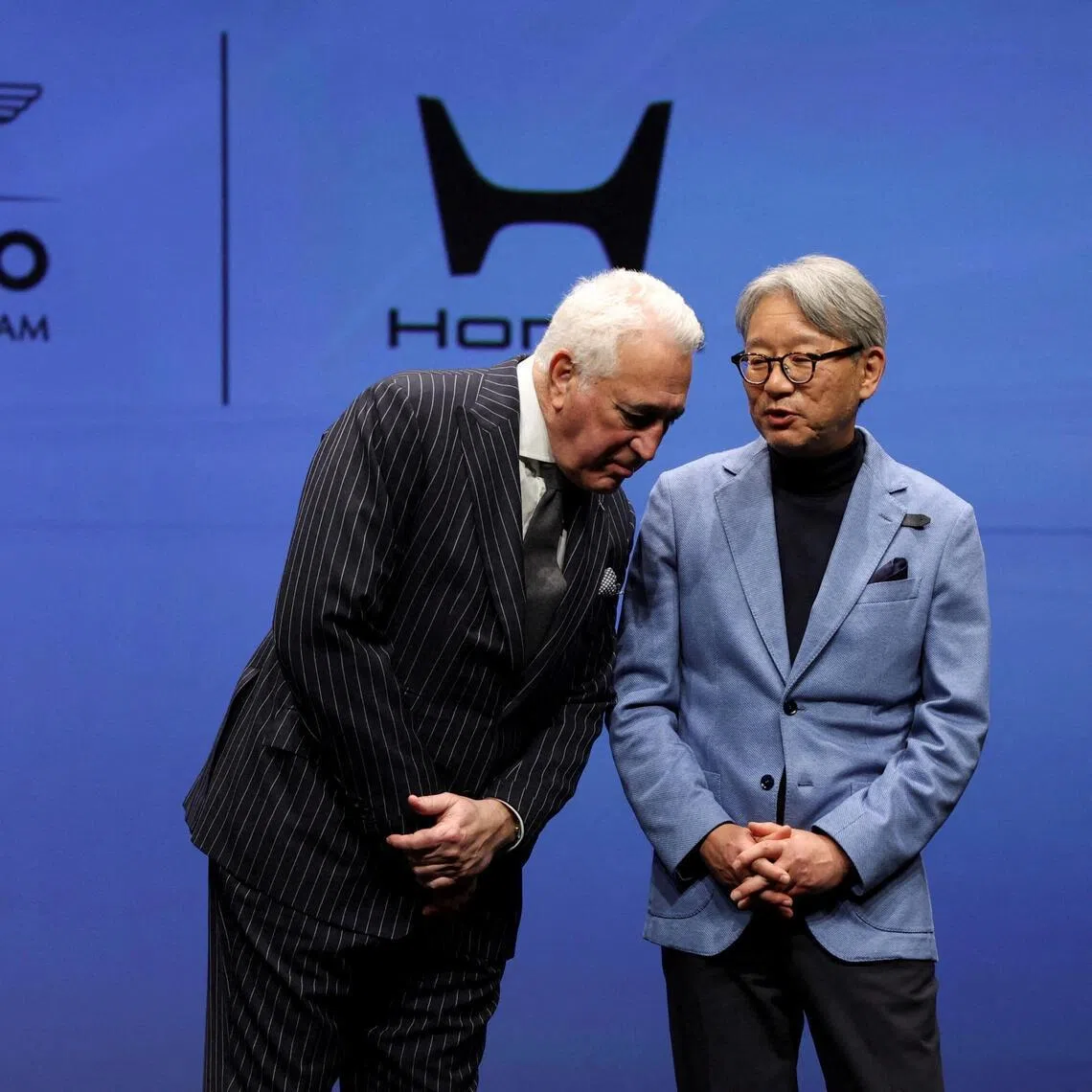 Aston Martin Formula One team owner Lawrence Stroll talking with Honda CEO Toshihiro Mibe during their joint-press conference on their partnership launch announcement in Tokyo on Jan 20, 2026.