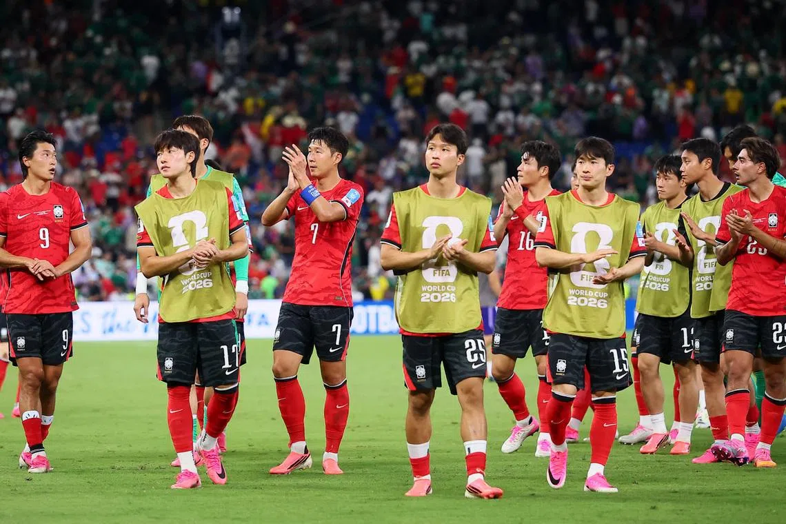 South Korea’s Bae Jun-ho, Son Heung-min, Eom Ji-sung, Kim Moon-hwan and teammates applaud their fans after their match against South Africa on June 24, in Monterrey, Mexico.