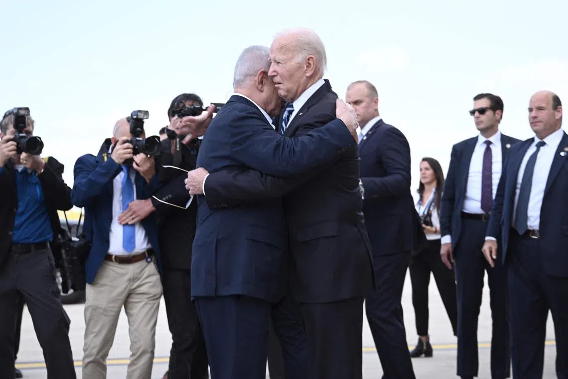 Israel Prime Minister Benjamin Netanyahu (left) greets US President Joe Biden upon his arrival at Tel Aviv's Ben Gurion airport on Oct 18, 2023.