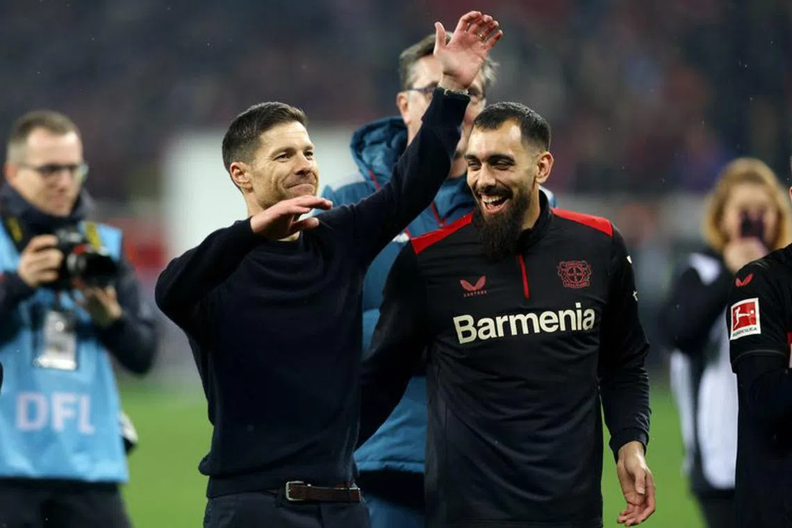 Soccer Football - Bundesliga - Bayer Leverkusen v Bayern Munich - BayArena, Leverkusen, Germany - February 10, 2024 Bayer Leverkusen coach Xabi Alonso celebrates with Borja Iglesias after the match REUTERS/Thilo Schmuelgen/ File Photo