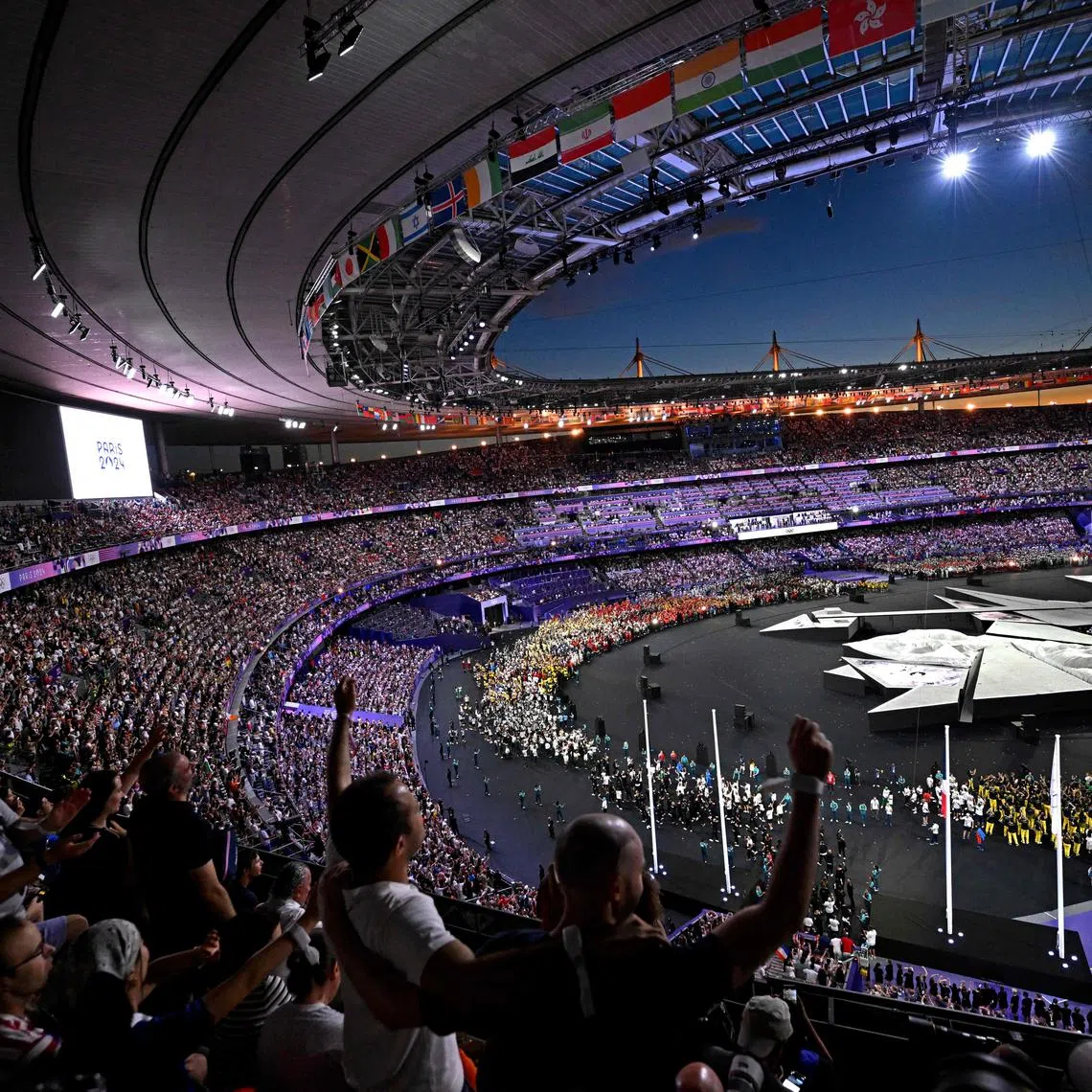 Spectators cheer during the closing ceremony of the Paris 2024 Olympic Games at the Stade de France, in Saint-Denis, on Aug 11, 2024.