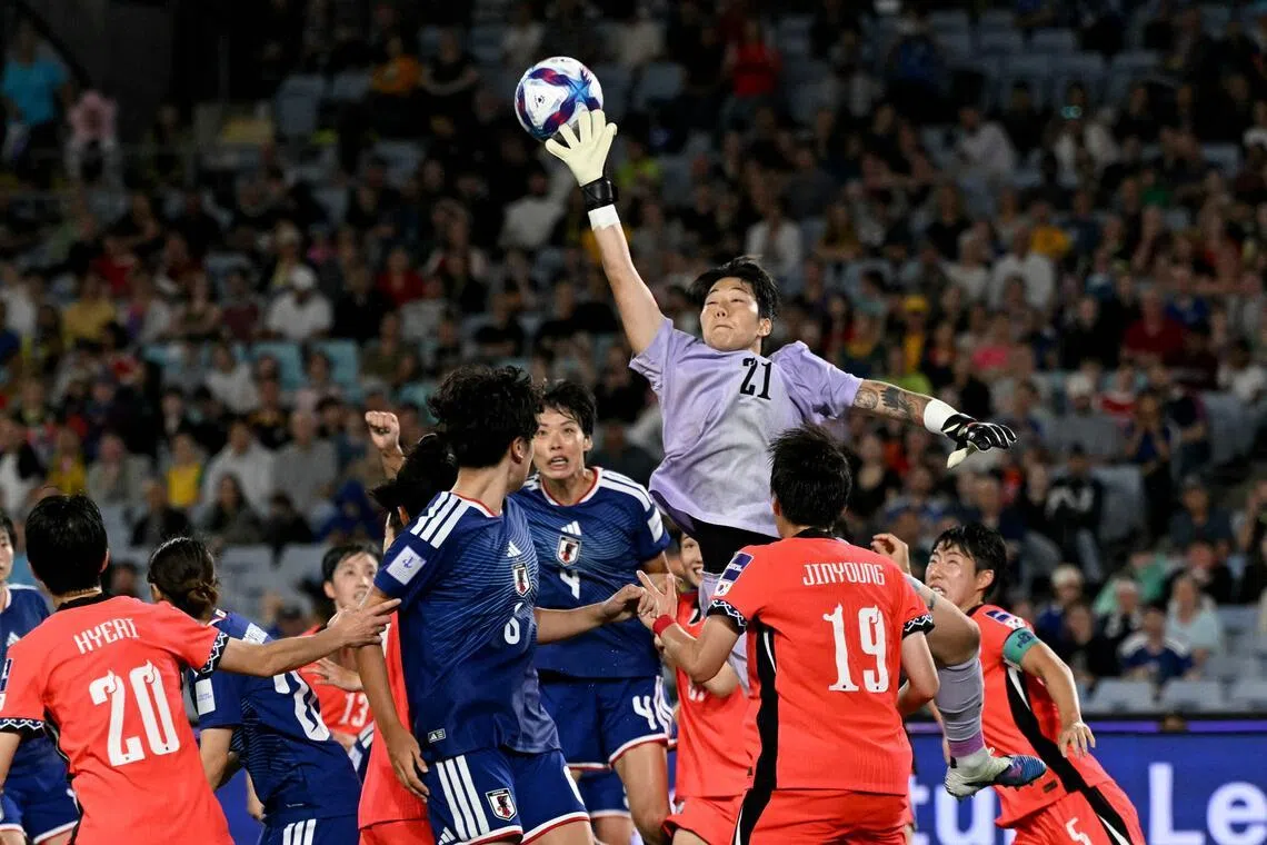 South Korea's goalkeeper Kim Min-jeong fails to hold on to a cross in the AFC Women’s Asian Cup semi-final against Japan at Stadium Australia in Sydney on March 18, 2026. Japan won 4-1.