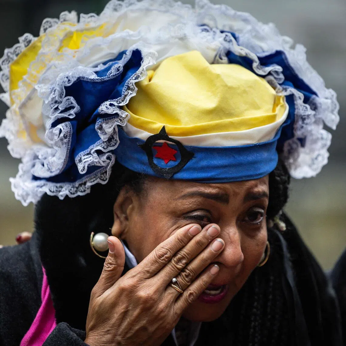 A resident of the Dutch territory of Bonaire - off Venezuela - weeping outside the court, after the Dutch government was ordered to do more to protect the island from the effects of climate change.  