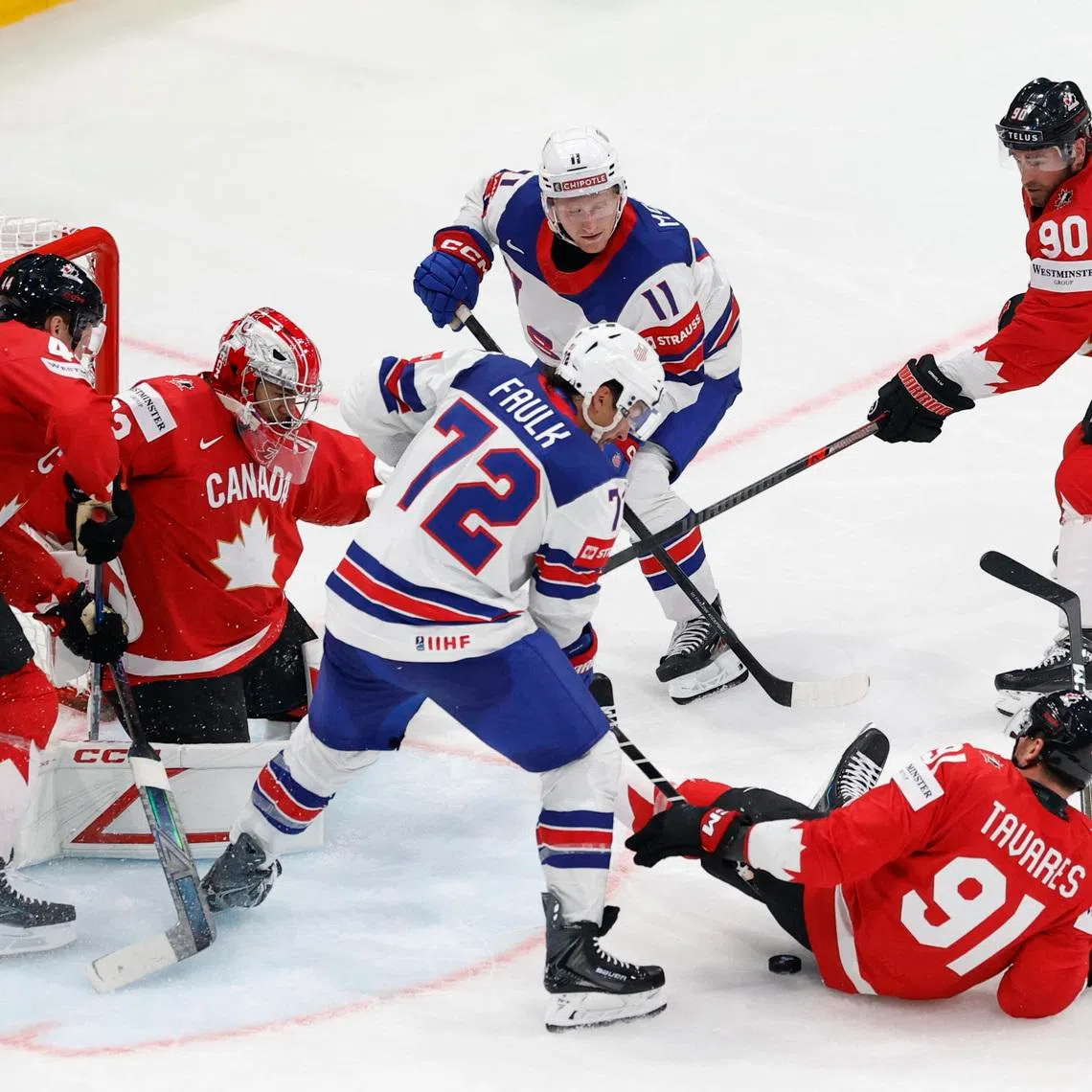 Ice Hockey - IIHF World Championships - Quarter Final - Canada v United States - BCF Arena, Fribourg, Switzerland - May 28, 2026 Justin Faulk and Oliver Moore of the U.S. in action with Canada's Morgan Rielly, John Tavares and Ryan O'Reilly REUTERS/David W Cerny