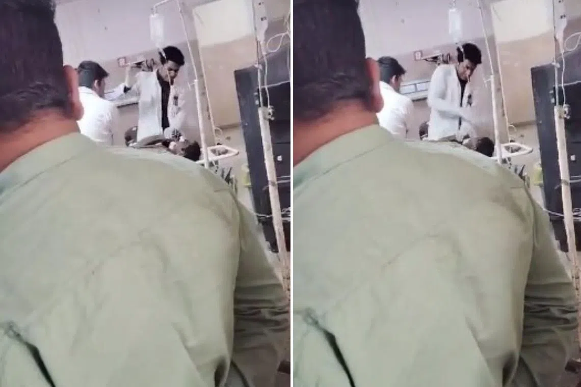 A doctor at a government-run hospital in India is seen in this screengrab slapping a patient on a gurney.