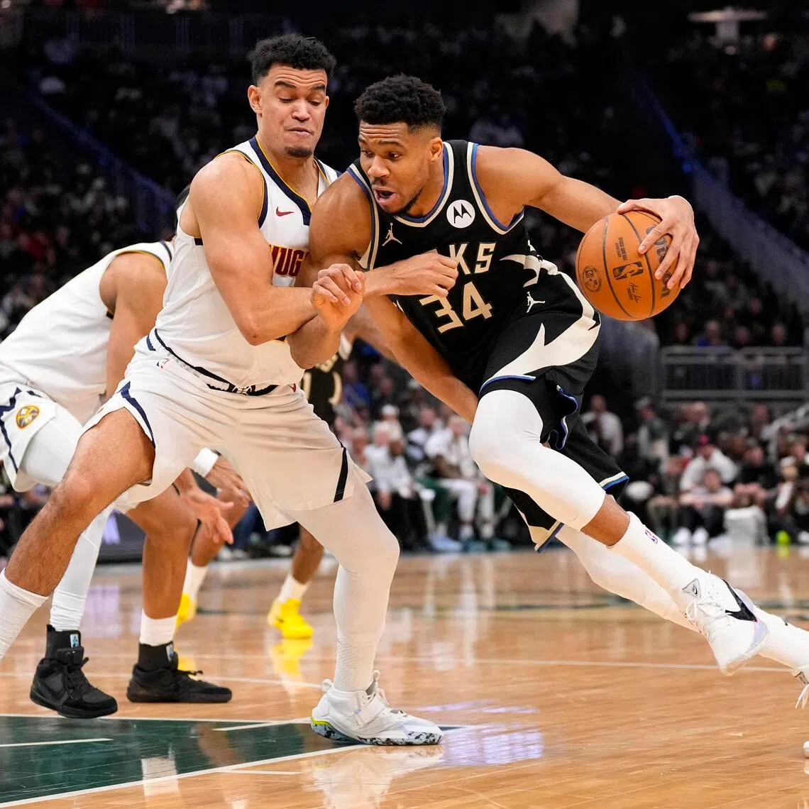 Milwaukee Bucks forward Giannis Antetokounmpo drives for the basket against Denver Nuggets forward Spencer Jones during their NBA game on Jan 23.