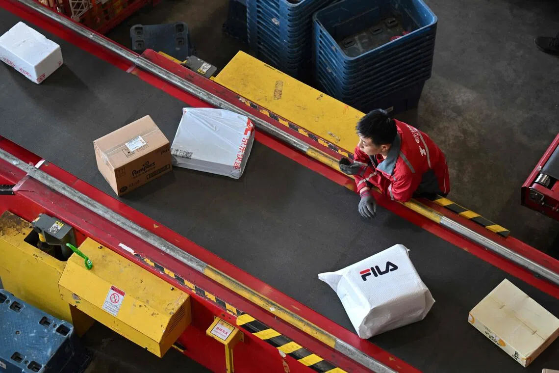 A worker sorting packages at JD.com’s warehouse in Beijing on Nov 11.