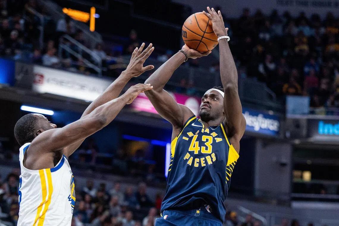 Indiana Pacers forward Pascal Siakam shooting the ball while Golden State Warriors forward Draymond Green defends in the second half at Gainbridge Fieldhouse. on Nov 1, 2025. Cameroonian playmaker Siakam tallied 27 points in his team's 114-109 win.