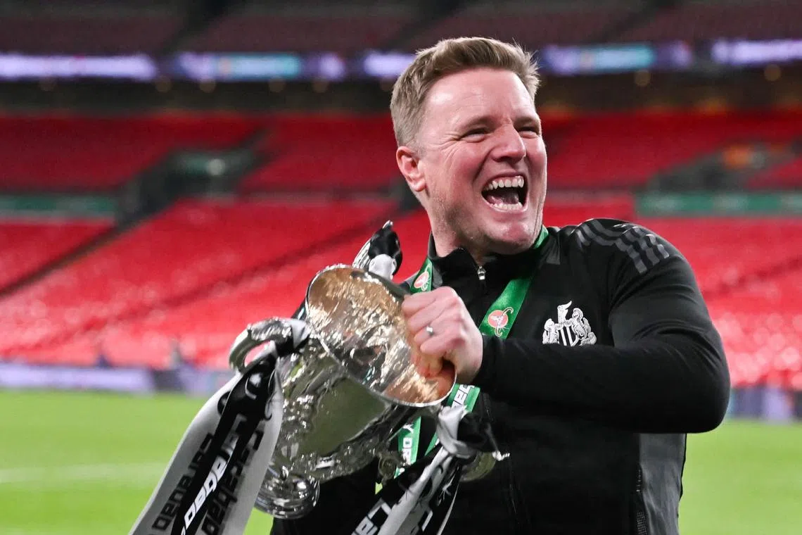 Newcastle United's manager Eddie Howe celebrates with the League Cup trophy after winning the English League Cup final on March 16.