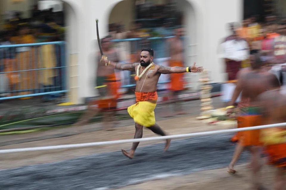 Devotees crossing the fire pit at Sri Mariamman Temple