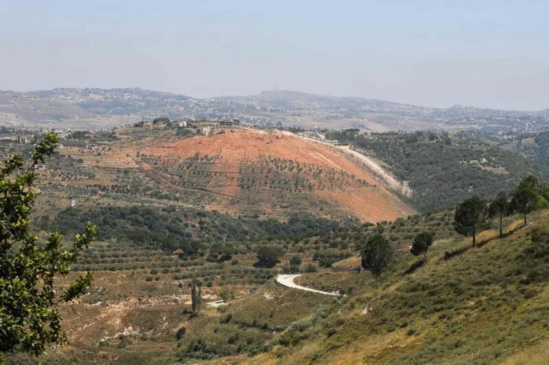 A photograph taken from the southern village of Ghandouriyeh on June 16 showing ejecta scattered around a crater reportedly left by the Israeli detonation of a Hezbollah tunnel network in Qantara.