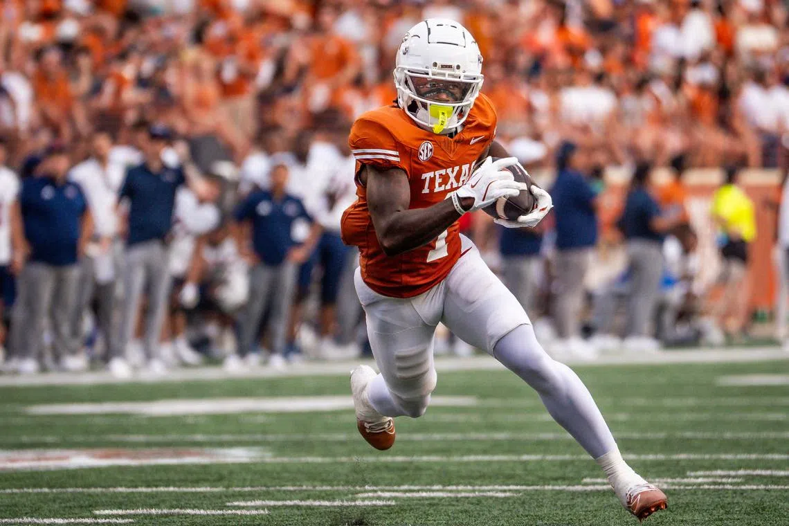 FILE PHOTO: Sep 14, 2024; Austin, Texas, USA; Texas Longhorns wide receiver Johntay Cook II (1) runs the ball for a touchdown against the UTSA Roadrunners in the first quarter at Darrell K RoyalÐTexas Memorial Stadium. Mandatory Credit: Sara Diggins/USA TODAY Network via Imagn Images/File Photo