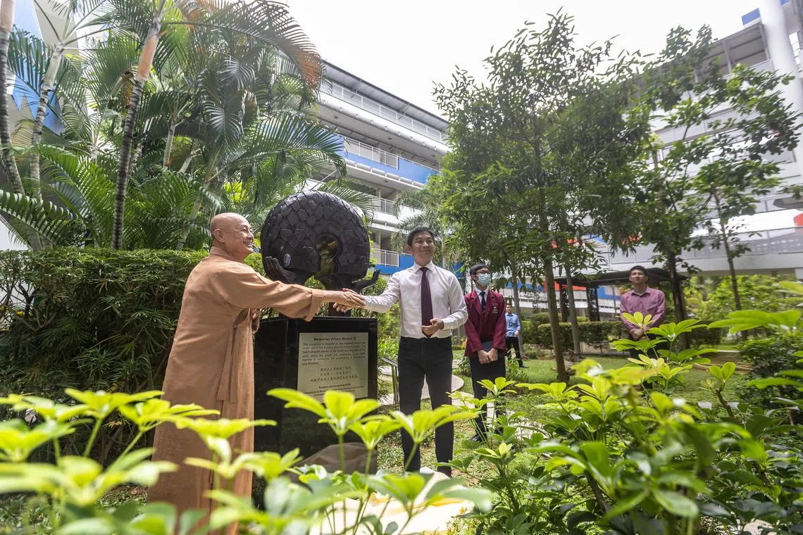 President of the  Manjusri Secondary School's management committee Venerable Seck Kwang Phin and Speaker of Parliament Tan Chuan-Jin unveiled one of the sculptures in the school.