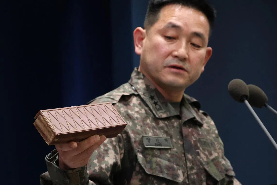 Yang Jin-hyeok, director of operations at South Korea’s joint chiefs of staff, holding up a previously recovered North Korean landmine during a briefing on Oct 5.