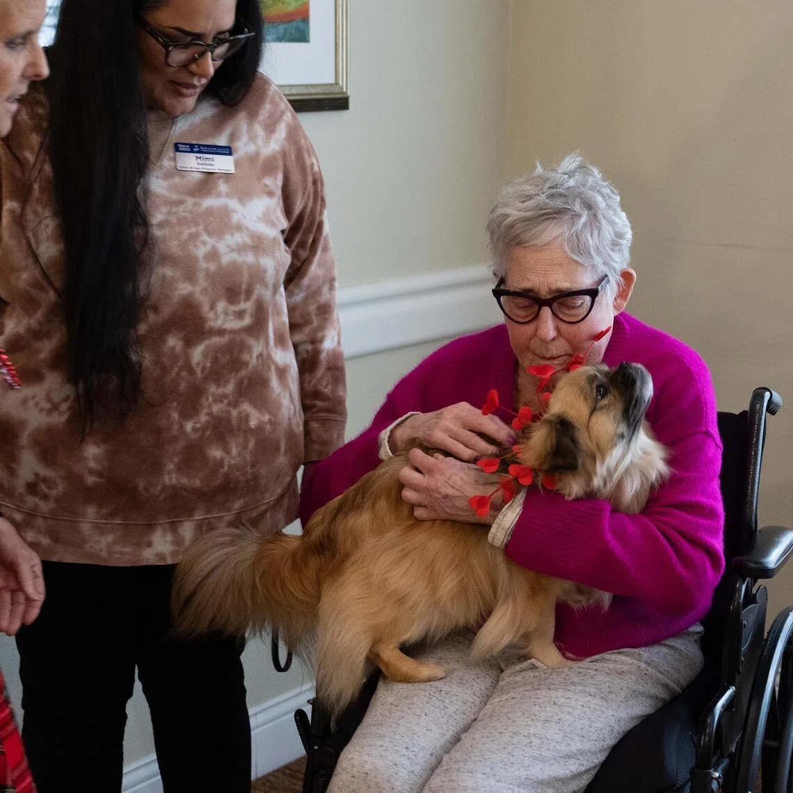 Kitty Lewis, left, and her dog, Nick, visit the residents at a Brookdale Senior Living Center in in Vancouver, Wash., Jan. 14, 2026. NickÕs job there is essentially to be himself, a 14-pound bundle of furry empathy. (Ruth Fremson/The New York Times)