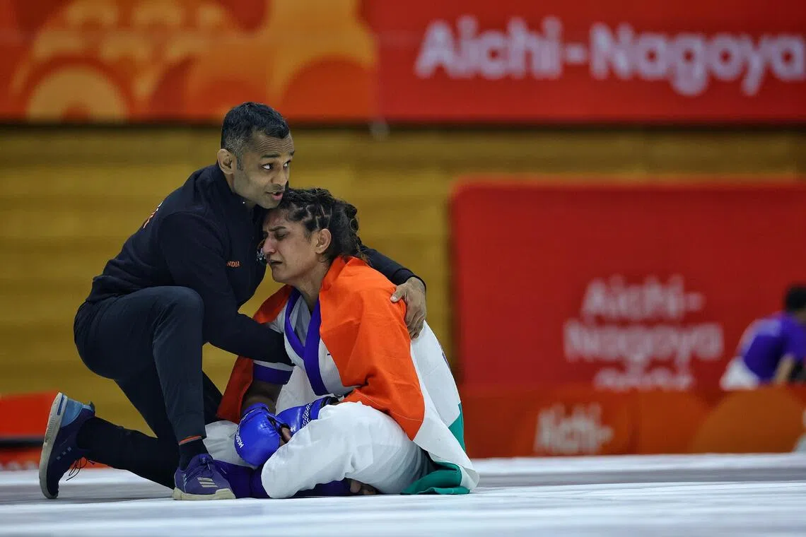 A disconsolate Suchika Tariyal of India staying on the mat after losing to Singapore’s Tiffany Teo on Sept 21.