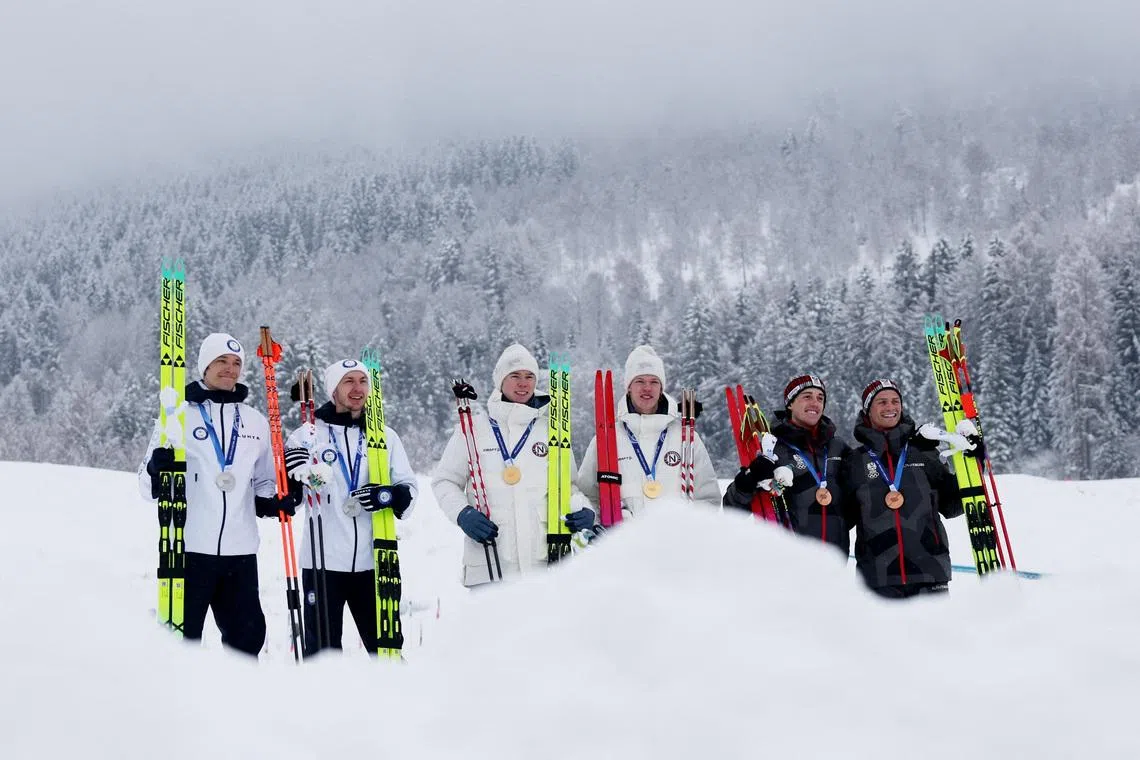 Milano Cortina 2026 Olympics - Nordic Combined - Team Sprint, Victory Ceremony - Tesero Cross-Country Skiing Stadium, Lago, Italy - February 19, 2026. Gold medallist's Andreas Skoglund of Norway and Jens Luraas Oftebro of Norway celebrate after winning the Team Sprint, with silver medallist's Ilkka Herola of Finland and Eero Hirvonen of Finland and bronze medallist's Stefan Rettenegger of Austria and Johannes Lamparter of Austria REUTERS/Kai Pfaffenbach