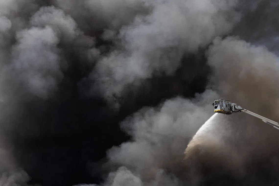 Firefighters working to extinguish a fire at an industrial facility in Bobigny, north of Paris, on June 17, 2026. 