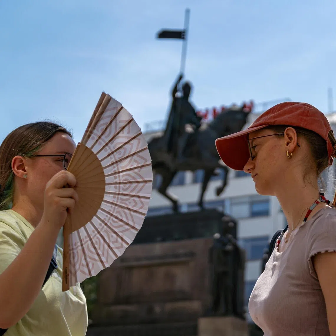 epa13069057 A woman uses a hand fan to keep cool during a hot, sunny day at Wenceslas Square in Prague, Czech Republic, 27 June 2026. According to meteorologists, temperatures in the Czech Republic reached 40 degrees Celsius for the first time since 2012, as readings continued to rise. A record set 20 August 2012 was also broken at one location in the northern part of the country, where 40.6 degrees Celsius was measured.  EPA/FADI YOUSEF