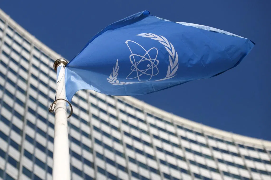 FILE PHOTO: A flag with the logo of the International Atomic Energy Agency (IAEA) waves in front of the IAEA headquarters in Vienna, Austria, March 1, 2021. REUTERS/Lisi Niesner/File Photo