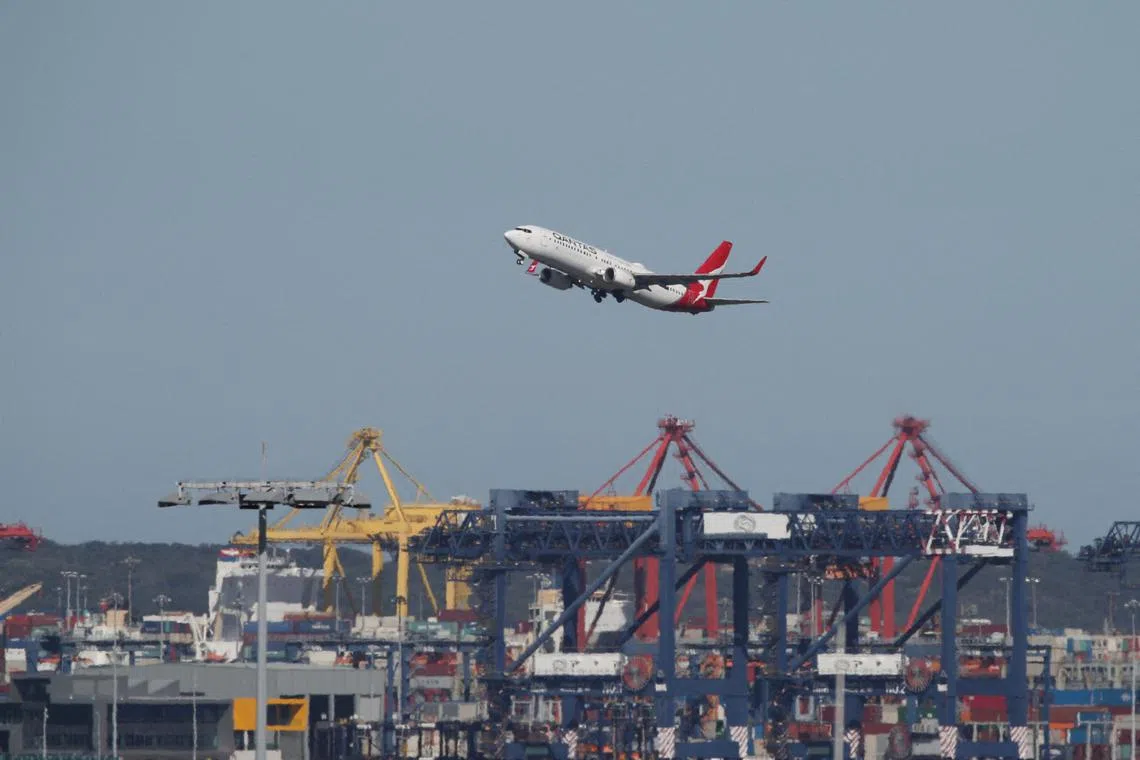 FILE PHOTO: A Qantas plane takes off from Kingsford Smith International Airport, in Sydney, Australia, March 18, 2020.  REUTERS/Loren Elliott/File Photo