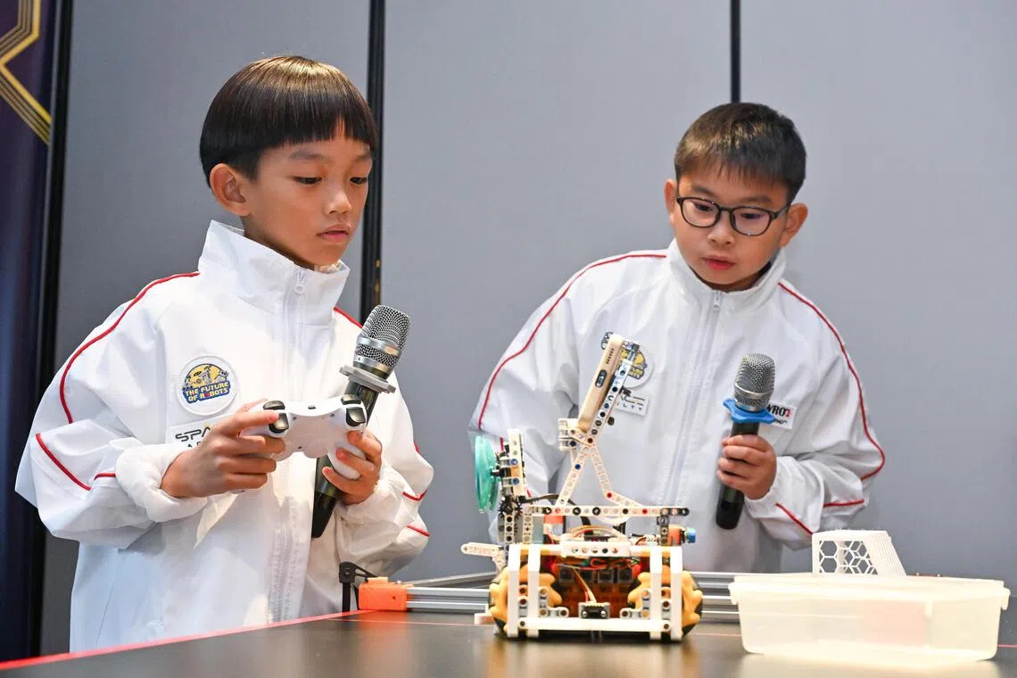 ST20251118-202545600901-Lim Yaohui-Sarah Koh-sarobot/
RoboBuddies team consisting of Chua Ming Feng Skylar, (right) 11, primary five student from Nanyang Primary School, and Elon Chan, 9, primary three student from New Town Primary School, giving a demonstration of their robot, during media preview at New Bahru on Nov 18, 2025.
The World Robot Olympiad (WRO), one of the world's leading global robotics championships, will be hosting its 2025 International Finals in Singapore from 26-28 November 2025. As the birthplace of WRO, which first began in Singapore in 2004, the championship’s return marks a full-circle moment for the global robotics community. The WRO International Finals will bring together over 500 teams and 3,000 participants from around the world, supported by dedicated local volunteers and international judges.
(ST PHOTO: LIM YAOHUI)