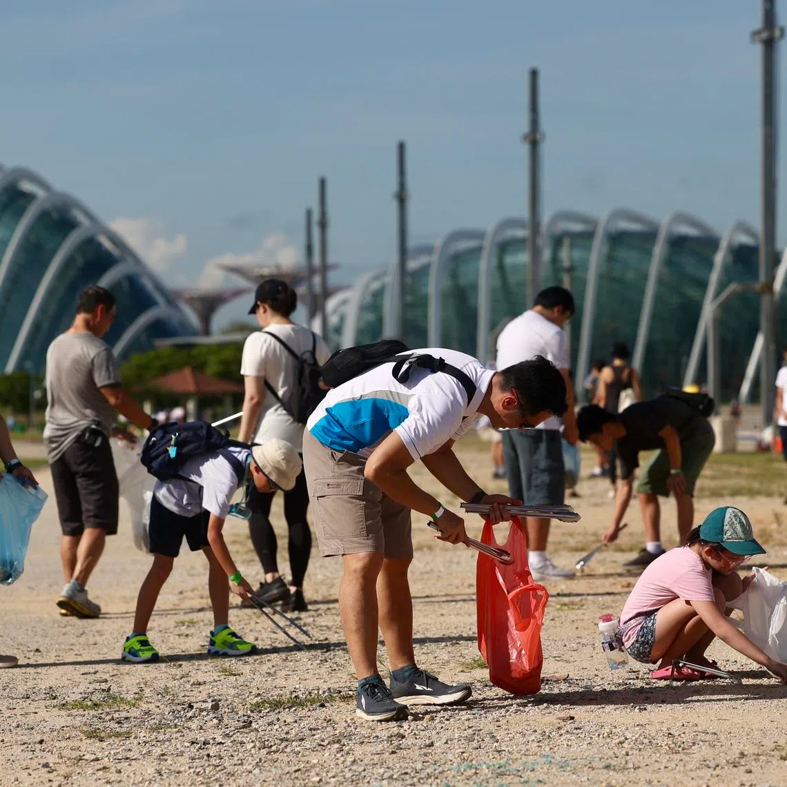 People taking part in SG Clean Day in the Marina Bay area in 2023. Overall, as a society, Singaporeans have become people used to paying others to clean up their mess.