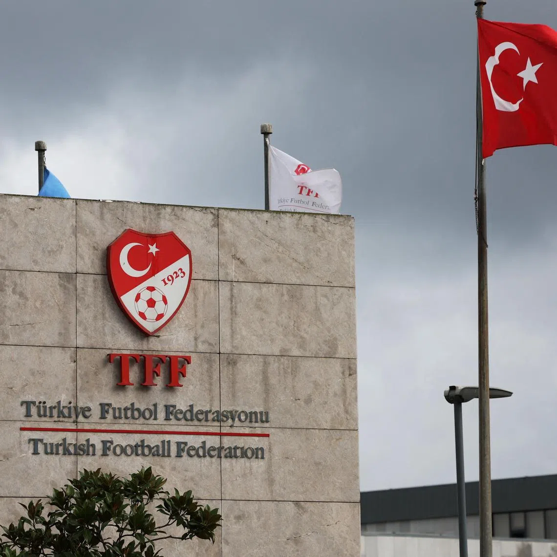 Soccer Football - Turkish Football Federation (TFF) Press Conference - Istanbul, Turkey - November 24, 2025 General view of Turkey football federation (TFF) logo alongside the Turkey flag REUTERS/Dilara Senkaya