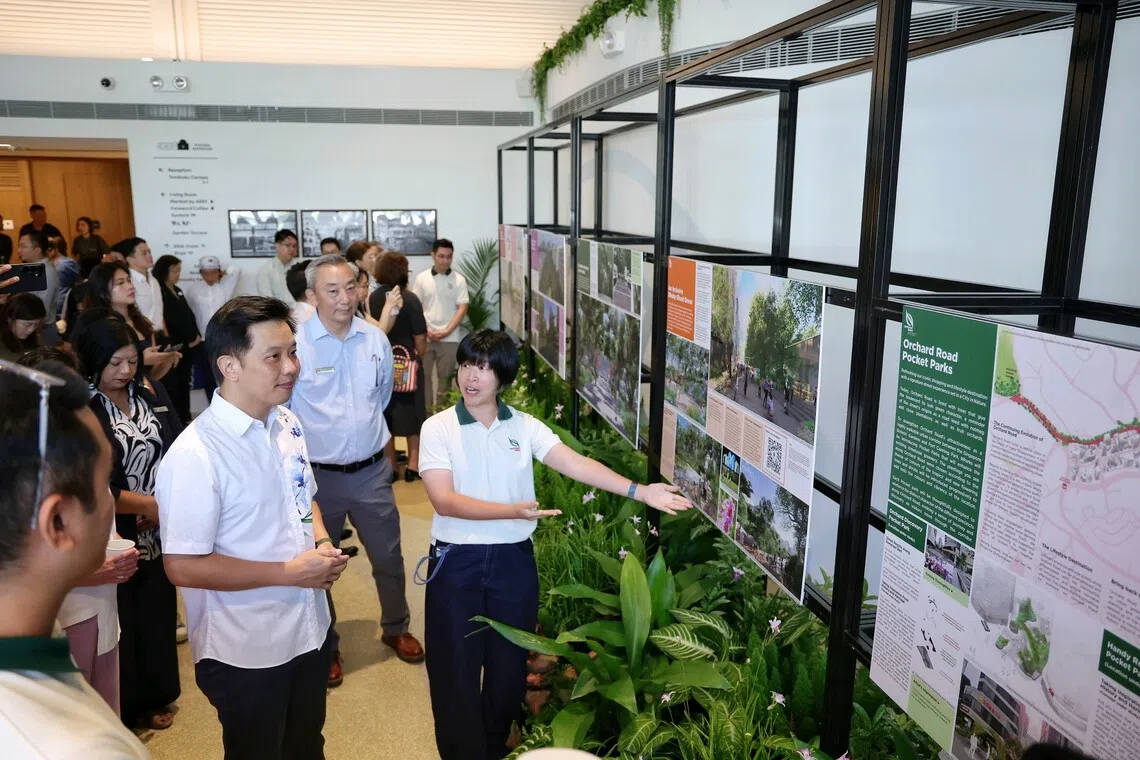 National Parks Board senior manager Alicia Soh taking Minister of State for National Development Alvin Tan through the exhibition panels showing updates to the rejuvenation plans for Istana Park and Dhoby Ghaut area at an event in Temasek Shophouse on Aug 12.