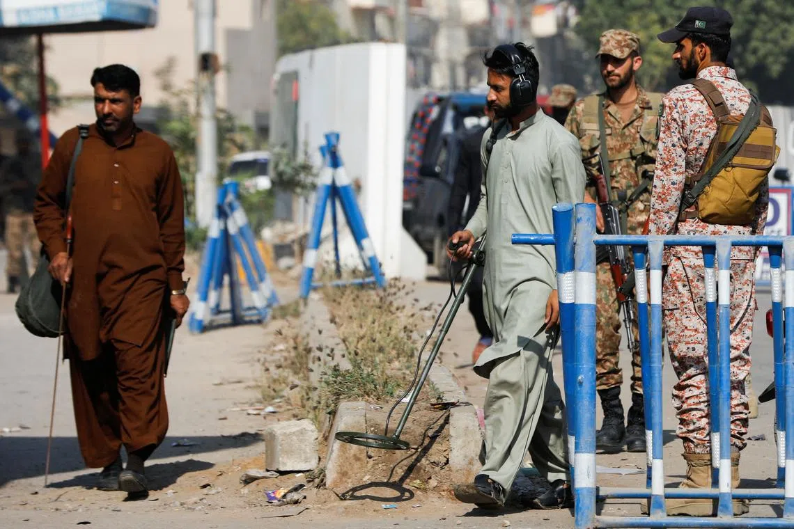 FILE PHOTO: Members of the bomb disposal squad in plain clothes, survey the area after yesterday's attack on a police station, in Karachi, Pakistan February 18, 2023. REUTERS/Akhtar Soomro/File Photo