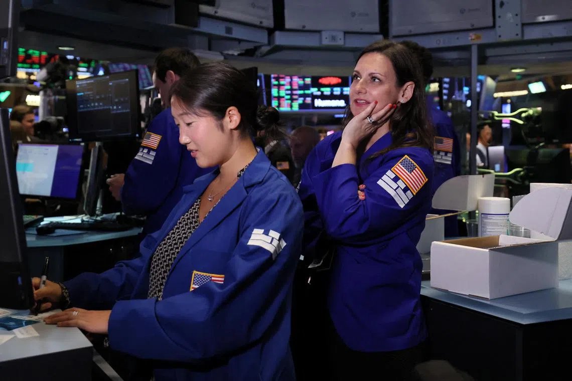 Traders work on the floor of the New York Stock Exchange, in New York City.