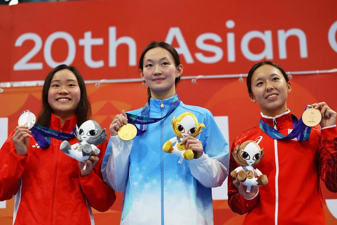Gold medallist China’s Li Bingjie (centre) celebrates on the podium after winning the women’s 1,500m freestyle final along with Singapore’s silver medallist Gan Ching Hwee (left) and Japan’s bronze medallist Ichika Kajimoto.