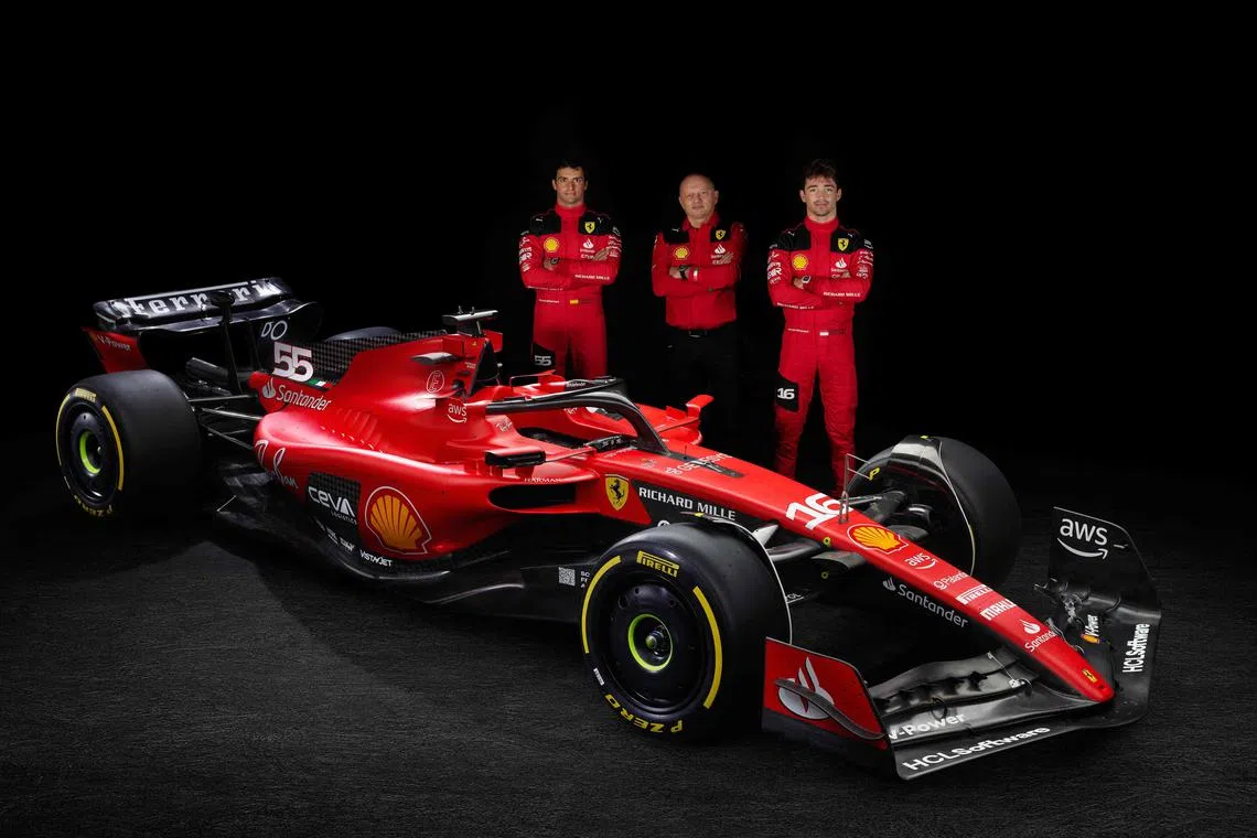 From left: Ferrari's Spanish driver Carlos Sainz, team principal Frederic Vasseur, and Monegasque driver Charles Leclerc posing by the new SF-23 car for the new season.