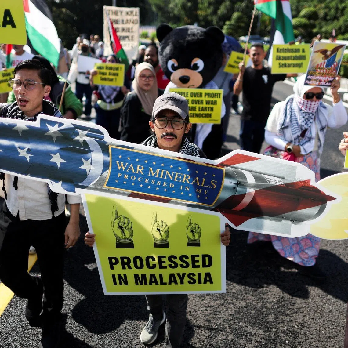 Malaysian activists hold placards bearing slogans, protesting Lynas Corp’s four-year rare earth supply agreement with the US Department of Defense in Malaysia.
