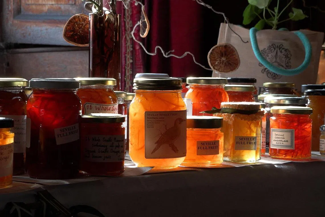 A screenshot taken from an AFP TV video, shows people browsing jars of marmalade entered into the annual Dalemain world marmalade awards, in Penrith, north west England, on April 20, 2024. On the steps of a centuries-old English country house, one of nation's most eccentric cultural events -– the Dalemain world marmalade awards -- was in full swing. Now in its 19th year, the competition drew 3,000 entries in multiple categories with the winning recipe going on to be sold in luxury London department store Fortnum & Mason. (Photo by Justine GERARDY / AFP) / TO GO WITH AFP STORY by Helen ROWE