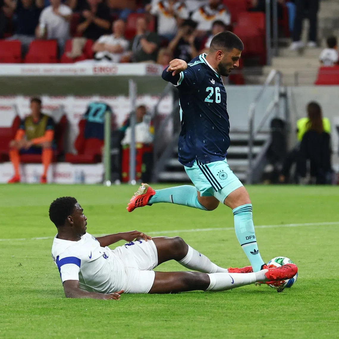 Germany's Deniz Undav scoring their third goal past a tackle from Finland defender Tony Miettinen in their 4-0 friendly win on May 31.