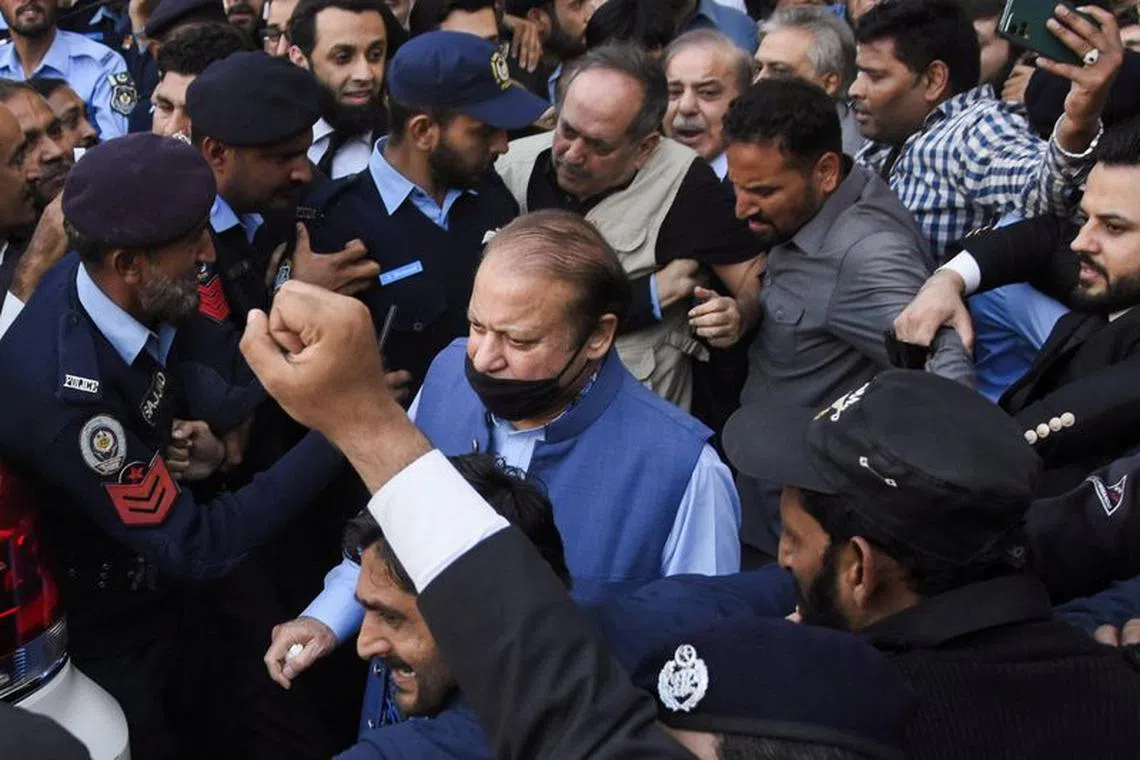 Pakistan's former Prime Minister Nawaz Sharif walks with party workers and police officers as he leaves after appearing at the Islamabad High Court, in Islamabad, Pakistan October 24, 2023. REUTERS/Waseem Khan NO RESALES. NO ARCHIVES.