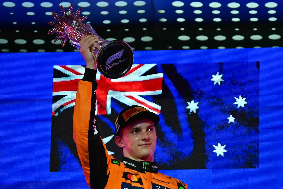 McLaren's Oscar Piastri celebrating on the podium after winning the 2025 Saudi Arabia Formula One Grand Prix at the Jeddah Corniche Circuit on April 20, 2025. 