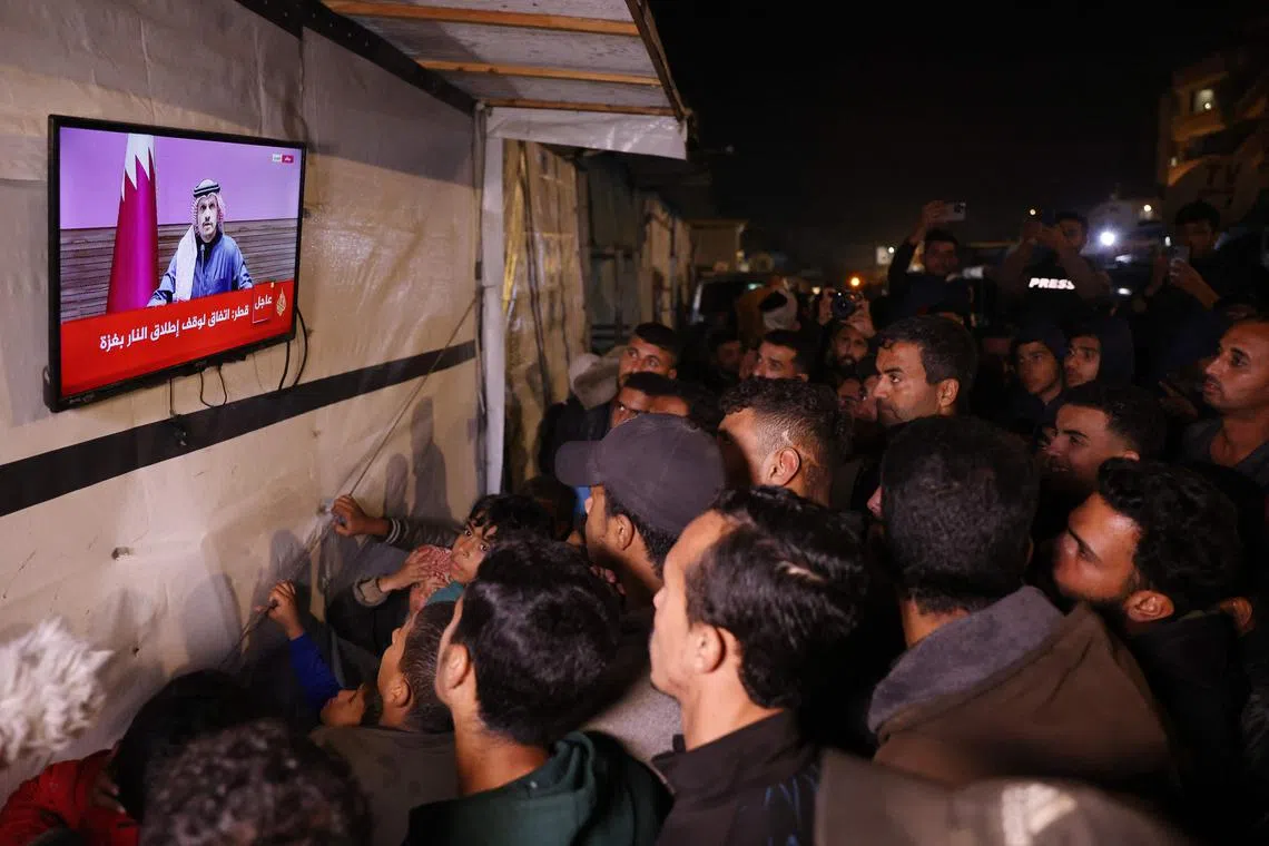 A live television broadcast of a press conference being addressed by Qatar’s Prime Minister Sheikh Mohammed bin Abdulrahman bin Jassim Al-Thani, along a street in Khan Yunis in the southern Gaza Strip, on Jan 15.