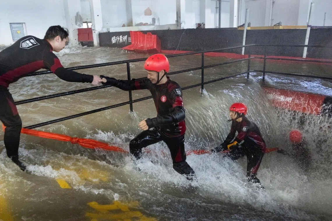 Participants practice evacuating an underground facility during a typhoon survival training session at the Lvxing Disaster Simulation Training Centre.