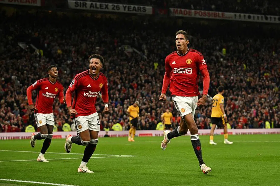 Soccer Football - Premier League - Manchester United v Wolverhampton Wanderers - Old Trafford, Manchester, Britain - August 14, 2023  Manchester United's Raphael Varane celebrates scoring their first goal with Jadon Sancho REUTERS/Dylan Martinez/ File Photo