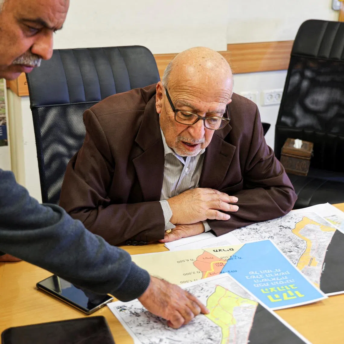 Director-general of the Applied Research Institute-Jerusalem, Jad Isaac, looks at the maps of Gaza during an interview, in Bethlehem, in the Israeli-occupied West Bank, on April 28.