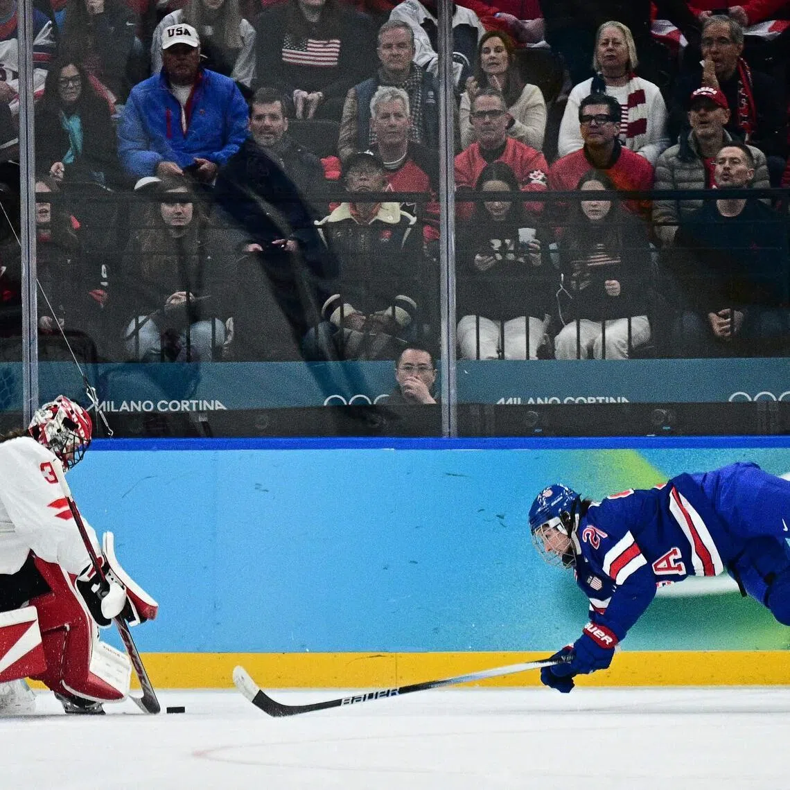 US forward Hilary Knight fights for the puck with Canada's goaltender Ann-Renee Desbiens in the women's ice hockey final at the Milano Cortina Winter Olympic Games in Milan, on Feb 19, 2026.