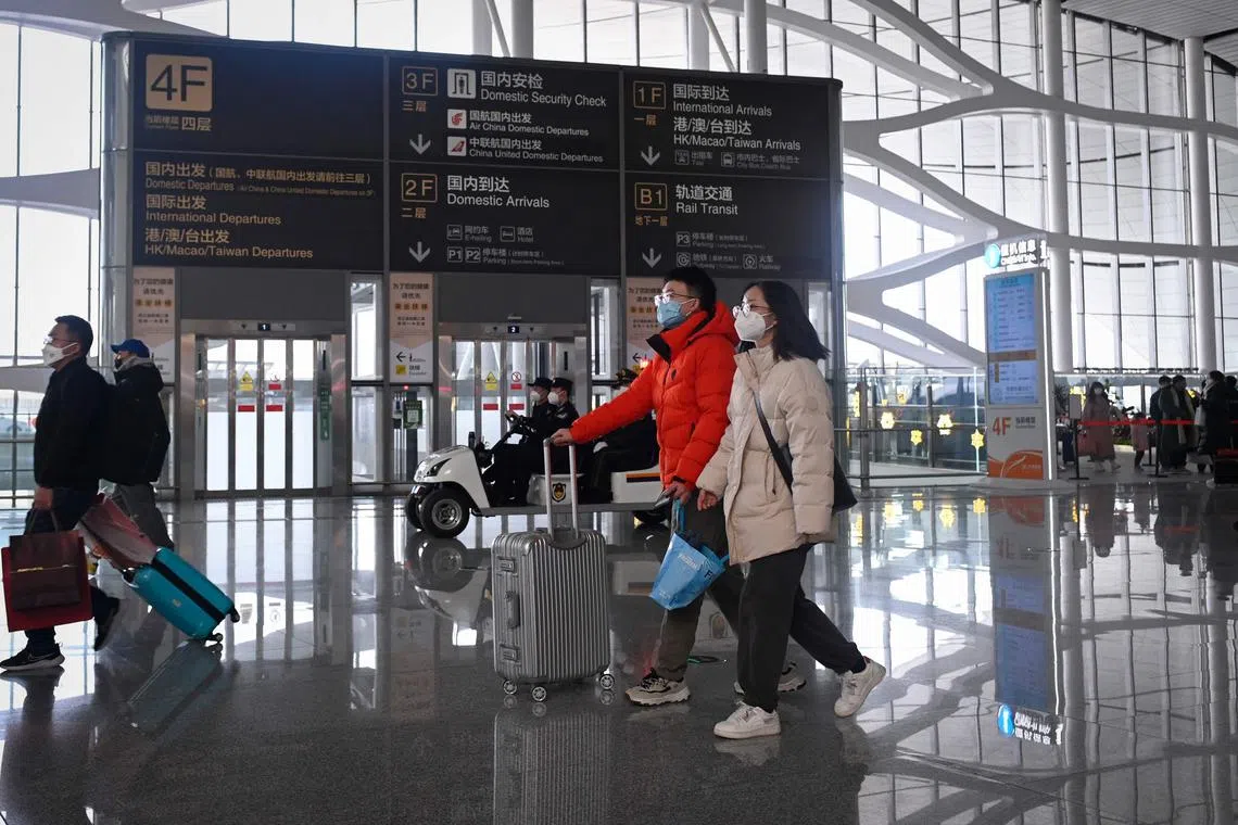 Passengers prepare to check in at Daxing International airport in Beijing on January 19, 2023. (Photo by WANG Zhao / AFP)