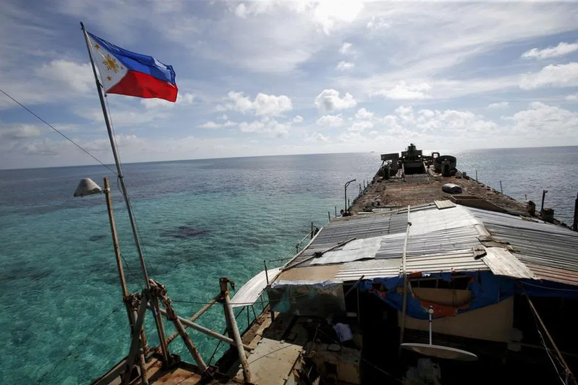 FILE PHOTO: A Philippine flag flutters from BRP Sierra Madre, a dilapidated Philippine Navy ship that has been aground since 1999 and became a Philippine military detachment on the disputed Second Thomas Shoal, part of the Spratly Islands, in the South China Sea March 29, 2014. REUTERS/Erik De Castro//File Photo