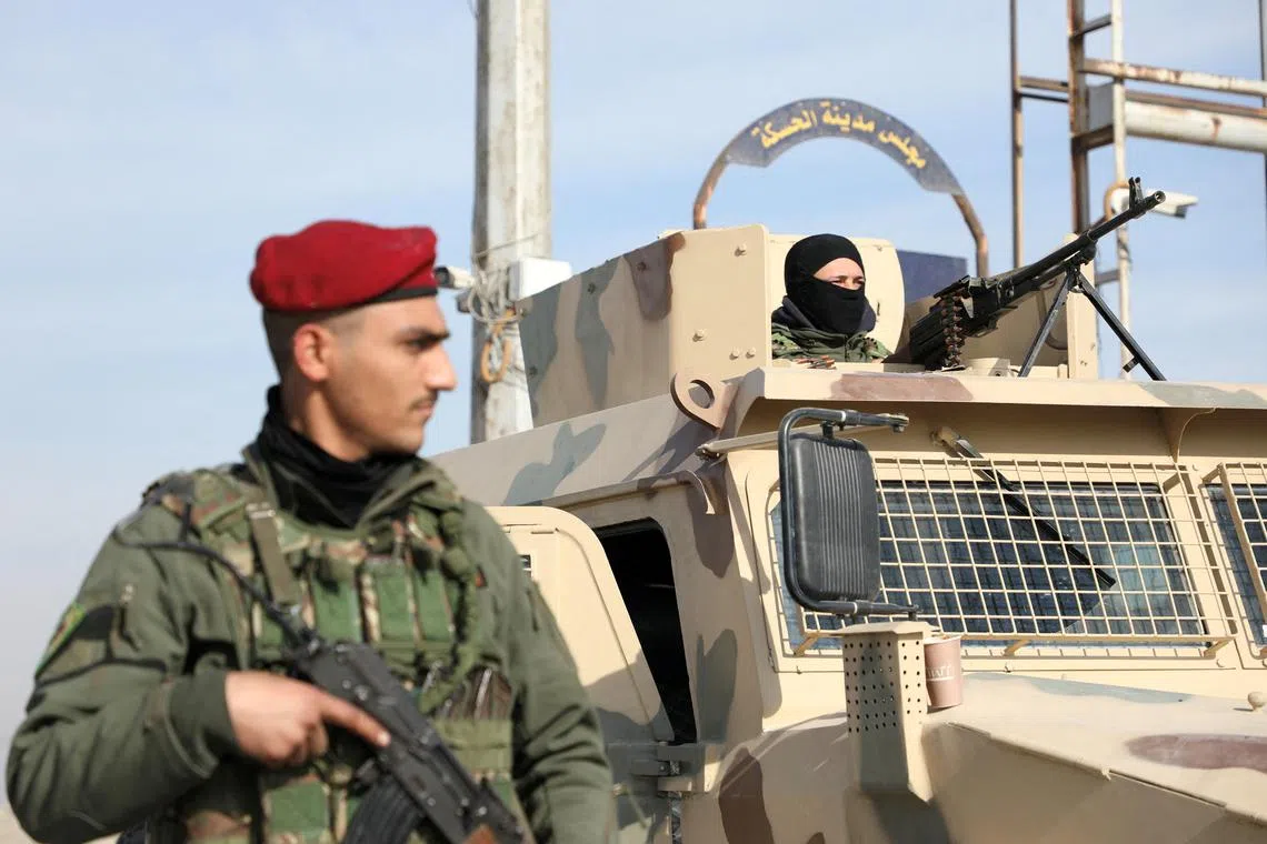 FILE PHOTO: A member of Kurdish-led Syrian Democratic Forces (SDF) stands along a street, after rebels seized the capital and ousted Syria's Bashar al-Assad, in Hasakah, Syria, December 11, 2024. REUTERS/Orhan Qereman/File Photo