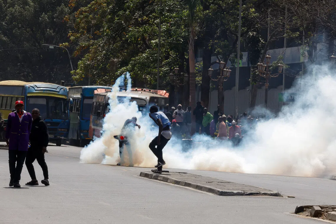 A demonstrator throws away a tear gas canister as traders hold a protest over a new Kenya Revenue Authority (KRA) customs valuation benchmark in downtown Nairobi, Kenya, August 28, 2026. REUTERS/Monicah Mwangi