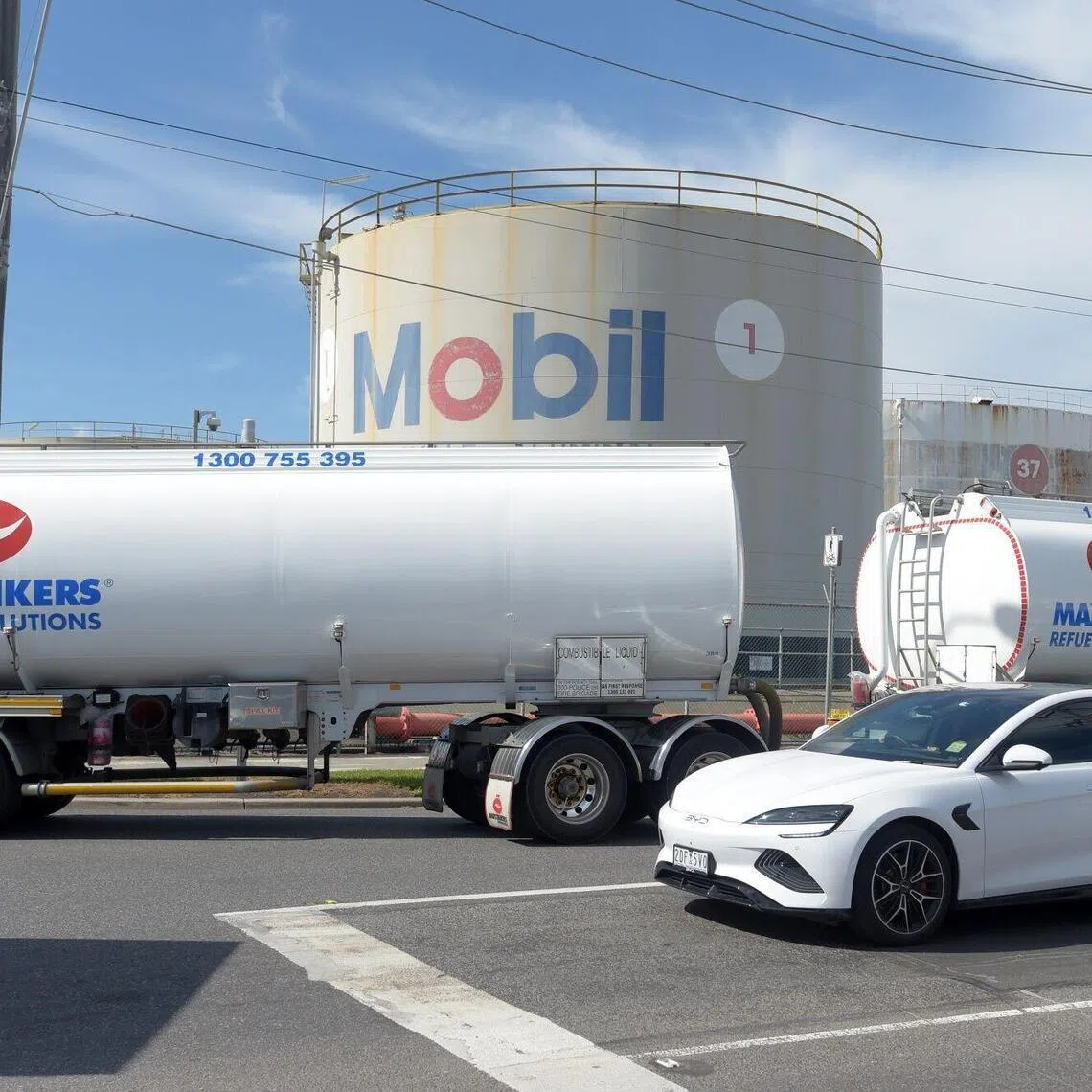 A Maxi-Tankers fuel tanker passes a fuel storage tank at the ExxonMobil Yarraville Terminal in Spotswood, Australia, on March 31, 2026. 