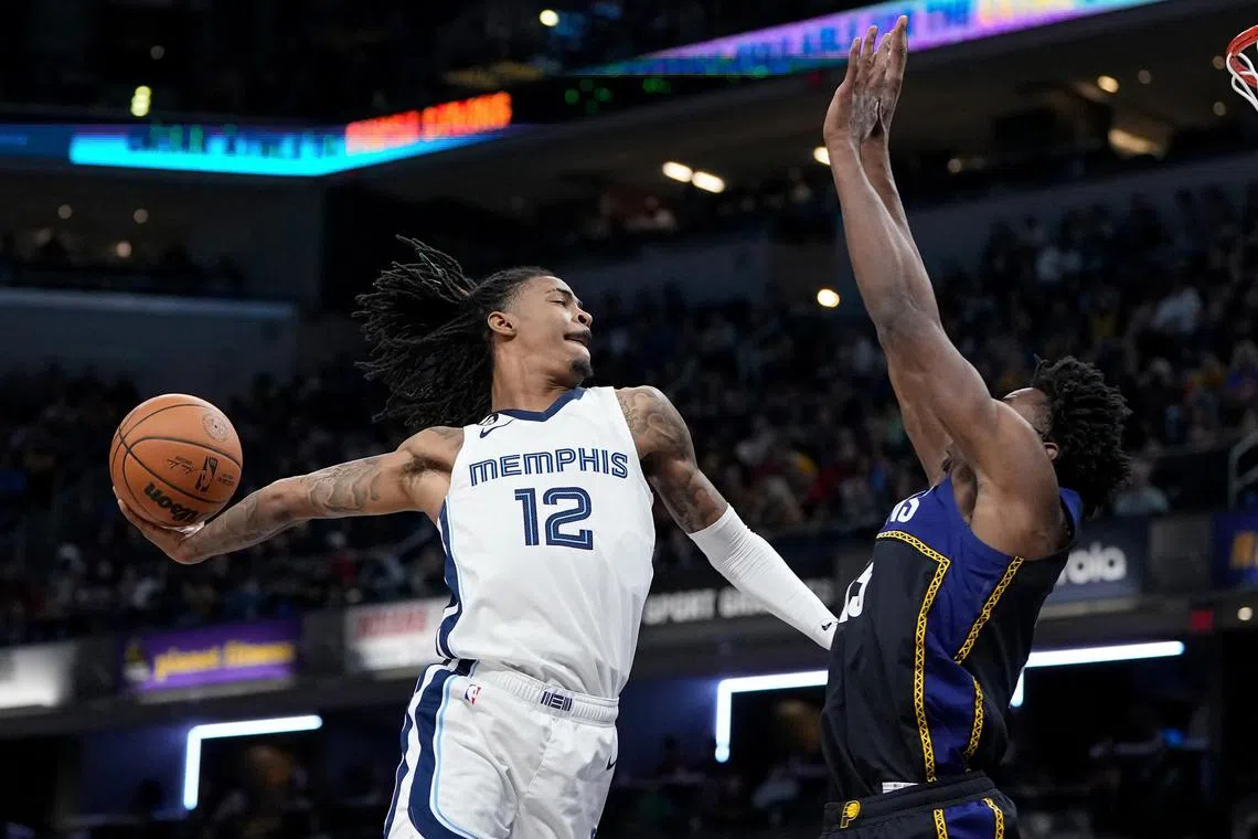 Ja Morant of the Memphis Grizzlies dunks the ball over Jalen Smith of the Indiana Pacers in the third quarter at Gainbridge Fieldhouse.